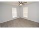 Spacious bedroom with two windows and a ceiling fan, ideal for rest and relaxation at 8659 Fancy Finch Dr # 202, Tampa, FL 33614