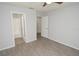 Bedroom with wood-style floors grants access to the bathroom and an additional bedroom at 8659 Fancy Finch Dr # 202, Tampa, FL 33614