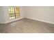 Light-filled bedroom offers views from balcony window and comfortable space for relaxation and rest at 8659 Fancy Finch Dr # 202, Tampa, FL 33614