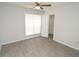 Bright bedroom features a ceiling fan, window, and walk-in closet with wood-style flooring at 8659 Fancy Finch Dr # 202, Tampa, FL 33614