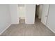 Neutral bedroom with wood-style floors provides access to the bathroom and additional bedroom at 8659 Fancy Finch Dr # 202, Tampa, FL 33614