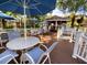 Comfortable cabana deck with tables, chairs, and blue umbrellas at 8659 Fancy Finch Dr # 202, Tampa, FL 33614