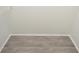 Walk-in closet with wood-look flooring, white walls, and wire shelving at 8659 Fancy Finch Dr # 202, Tampa, FL 33614