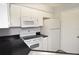 Updated kitchen with white appliances, black countertops, and ample cabinet space at 8659 Fancy Finch Dr # 202, Tampa, FL 33614