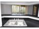 View from kitchen featuring a stainless steel sink and a balcony window at 8659 Fancy Finch Dr # 202, Tampa, FL 33614