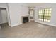Comfortable living room featuring a cozy fireplace and a window with view of a balcony at 8659 Fancy Finch Dr # 202, Tampa, FL 33614
