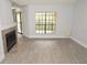 Inviting living room features a fireplace, balcony access, and neutral walls for easy customization at 8659 Fancy Finch Dr # 202, Tampa, FL 33614