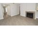 Open-concept living room with a fireplace and updated flooring, perfect for entertaining at 8659 Fancy Finch Dr # 202, Tampa, FL 33614