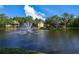 Scenic view of a tranquil pond with a fountain, surrounded by community buildings at 8659 Fancy Finch Dr # 202, Tampa, FL 33614
