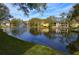 Scenic view of a pond with a fountain, surrounded by community buildings and lush greenery at 8659 Fancy Finch Dr # 202, Tampa, FL 33614