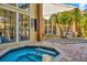 Exterior view of a spa with brick pavers and large windows showing exercise equipment at 8659 Fancy Finch Dr # 202, Tampa, FL 33614
