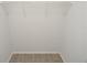 Walk-in closet with wire shelving and wood-style floors at 8659 Fancy Finch Dr # 202, Tampa, FL 33614