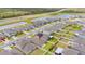 Scenic aerial of neighborhood with a lake view, green space, and home featuring well-maintained landscaping at 9313 Channing Hill Dr, Ruskin, FL 33573
