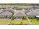 Aerial view of backyard featuring a well-maintained lawn, patio, and white fence for privacy and outdoor enjoyment at 9313 Channing Hill Dr, Ruskin, FL 33573