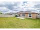 A spacious backyard with a well-maintained lawn, a patio and white fence providing privacy at 9313 Channing Hill Dr, Ruskin, FL 33573