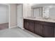 Bathroom featuring double sinks, ample counter space, and walk-in shower at 9313 Channing Hill Dr, Ruskin, FL 33573