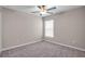 Bright bedroom with a ceiling fan, plush carpet, and a window allowing natural light at 9313 Channing Hill Dr, Ruskin, FL 33573