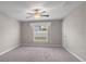Cozy bedroom with carpet, ceiling fan, and natural light from a large window at 9313 Channing Hill Dr, Ruskin, FL 33573