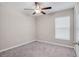 Bright bedroom with a ceiling fan, plush carpet, and a window allowing natural light at 9313 Channing Hill Dr, Ruskin, FL 33573