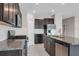 Modern kitchen with stainless steel appliances, granite countertops, and dark wood cabinets at 9313 Channing Hill Dr, Ruskin, FL 33573
