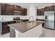 Modern kitchen featuring stainless steel appliances, granite countertops, and dark wood cabinetry at 9313 Channing Hill Dr, Ruskin, FL 33573