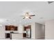 Open-concept kitchen with dark wood cabinets, stainless steel appliances, and a large island at 9313 Channing Hill Dr, Ruskin, FL 33573