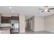 Spacious open floor plan features sleek kitchen with stainless steel appliances, and views to the living area at 9313 Channing Hill Dr, Ruskin, FL 33573