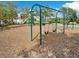 Community playground featuring a slide and swings surrounded by mulch at 9313 Channing Hill Dr, Ruskin, FL 33573