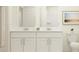 Bright bathroom featuring a dual sink vanity, modern fixtures, and neutral color scheme at 9352 Bonita Mar Dr, Parrish, FL 34219
