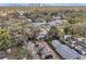 Aerial view of a property with a shed and brick driveway, nestled among trees and city skyline in the background at 1105 E 33Rd Ave, Tampa, FL 33603