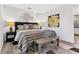 Bedroom with a striped bedspread, bench, and decorative artwork at 1150 Oak Ne St, St Petersburg, FL 33701