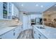 Well-appointed kitchen featuring white cabinets, quartz countertops, and stainless steel appliances in a light color scheme at 11882 Frost Aster Dr, Riverview, FL 33579