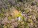 Expansive property showing the roof, surrounding trees, and structures in a secluded, wooded area at 13381 Glory Ln, Brooksville, FL 34614