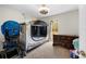 Cozy room with soft carpet, natural light, a wooden dresser, and door to outside at 13381 Glory Ln, Brooksville, FL 34614