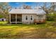 Charming exterior featuring a screened-in porch, wooden deck, metal roof and a cozy, rustic-style home at 13381 Glory Ln, Brooksville, FL 34614