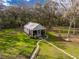 Charming cottage-style home with metal roof, screened porch, and mature trees on a spacious lot at 13381 Glory Ln, Brooksville, FL 34614