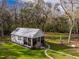 Charming home with a metal roof, screened porch, spacious yard, stone pathway and wooded surroundings at 13381 Glory Ln, Brooksville, FL 34614
