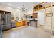 Open kitchen with stainless steel appliances, wood cabinets, and natural light at 13381 Glory Ln, Brooksville, FL 34614