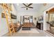 Living room with a cozy seating area, fireplace, ladder and outside patio view at 13381 Glory Ln, Brooksville, FL 34614