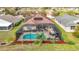 Aerial view of the home showing screened-in pool, patio, outdoor kitchen and landscaping at 13422 Niti Dr, Hudson, FL 34669