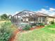 The home features a screened-in pool with an outdoor kitchen and patio area at 13422 Niti Dr, Hudson, FL 34669