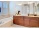 Elegant bathroom features double sinks, a soaking tub, and granite countertops at 13422 Niti Dr, Hudson, FL 34669