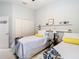 Bedroom featuring two twin beds, closet space, and accent decor on floating shelves at 13422 Niti Dr, Hudson, FL 34669
