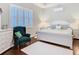 Bright bedroom featuring plantation shutters and ensuite bathroom at 13422 Niti Dr, Hudson, FL 34669