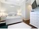 Comfortable bedroom with a tray ceiling and wooden floors at 13422 Niti Dr, Hudson, FL 34669