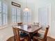 Cozy breakfast nook with wood table, plantation shutters, and lots of natural light at 13422 Niti Dr, Hudson, FL 34669