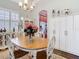 Bright dining area with a round wood table with seating and white cabinets at 13422 Niti Dr, Hudson, FL 34669