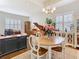 Bright dining area with a round wood table with seating, a piano, and a desk at 13422 Niti Dr, Hudson, FL 34669