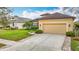 Exterior of the home showing a well-manicured lawn, 2-car garage and shrubbery at 13422 Niti Dr, Hudson, FL 34669