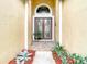 Charming double front doors framed by decorative plants and mulch create an inviting entrance at 13422 Niti Dr, Hudson, FL 34669